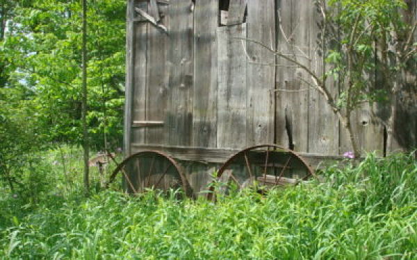 A picture of the front side of an old barn with naturally aged barnwood.